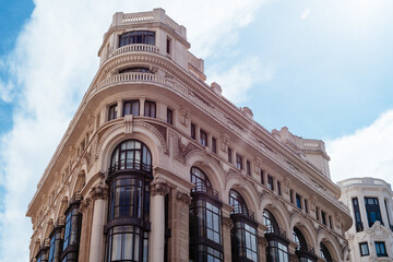 Fototapeta premium Historic buildings in Gran Via, the iconic avenue of Madrid famous for his cinemas and stores