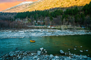 Rafting : boat moving on quiet  river section-river Beas . next to Kullu town in Himachal Pradesh., India - obrazy, fototapety, plakaty