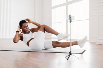 Black Woman Doing Twist Crunches Exercise On Camera