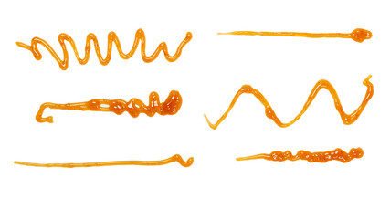 Orange apricot jam splashes isolated on white background. Top view.