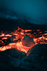 Atmospheric close-up view of flowing lava at volcano eruption site in Geldingadalir, Iceland —...