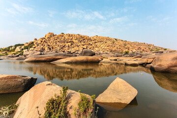 Fototapeta na wymiar Big boulders and rocks along the Chakrairtha Lake in Hampi, Karnataka, South India - Asia