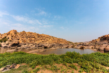 Big boulders and rocks along the Chakrairtha Lake in Hampi, Karnataka, South India - Asia