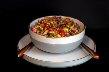 Nutty wholefood salad garnished with pomegranate, a tasty vegan lunch
