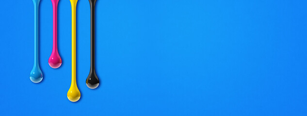 cmyk ink drops on blue paper banner background