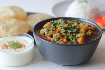 Bottle Gourd Curry with Lentils served with steamed basmati rice and deep fried whole wheat Indian flat brea