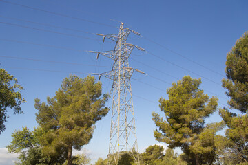 Power lines during a beautiful sunset. Electricity transportation on beautiful landscapes of the world.