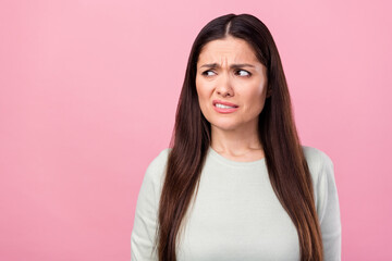 Photo of unhappy disgusted mature woman look empty space dislike face grimace isolated on pink...