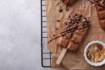 Chocolate ice cream popsicle with nut