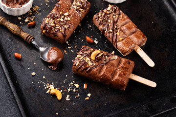 Chocolate ice cream popsicle with nut