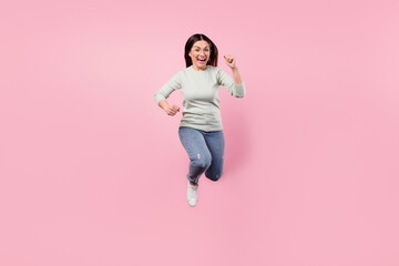 Full size photo of attractive excited happy lady jump up runner you isolated on pastel pink color background