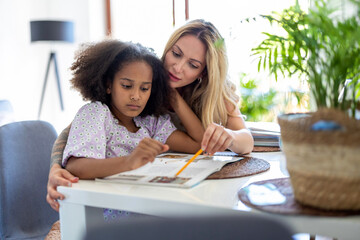 Mother helping daughter with homework 
