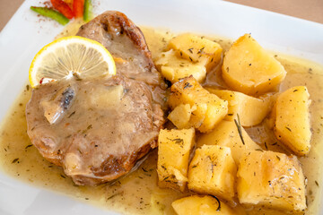 Braised lamb in gravy served with potatoes at the restaurant. Traditional Greek dish.
