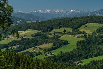 Naklejka na ściany i meble Pass near Niederer Schockl hill with green meadows and fences in Austria