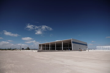 Nave industrial, Package Boxes with Hand Pallet Truck Load into Cargo Container. Truck Parked...