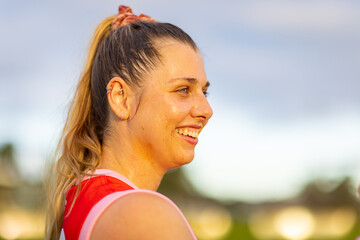 woman footballer with sun on her face highlighting the sweat
