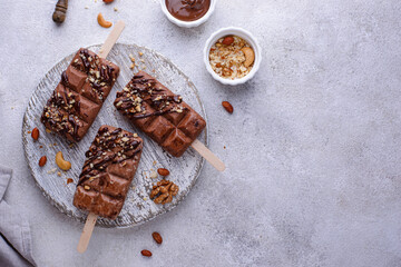 Chocolate ice cream popsicle with nut
