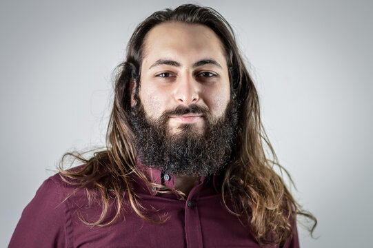 Portrait Of A Young Middle Eastern Businessman With Beard And Long Hair