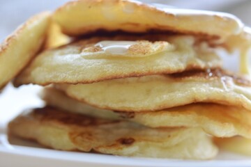 homemade pancakes with condensed milk close-up on a plate