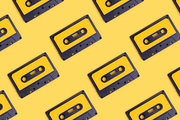Cassette tapes pattern on a yellow background. Creative concept.