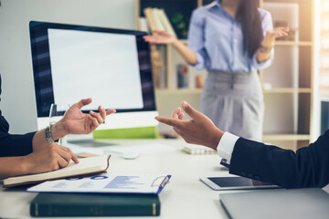 Close-up of a team of businessmen having a brainstorming meeting provide collaborative ideas using graph and document at the office.