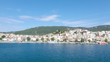 Naklejka na ściany i meble Skiathos Island, Greece - June 2020. View of the city of Skiathos by a boat.