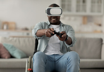 African american millennial man relax in living room interior, play video game, using gamepad