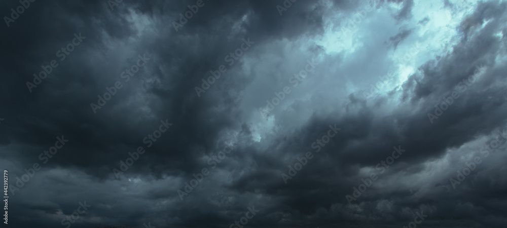 Poster the dark sky had clouds gathered to the left and a strong storm before it rained.bad or moody weathe