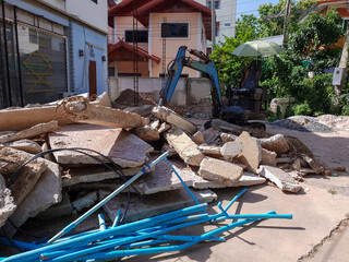 Small backhoe,Unsafe house demolition.