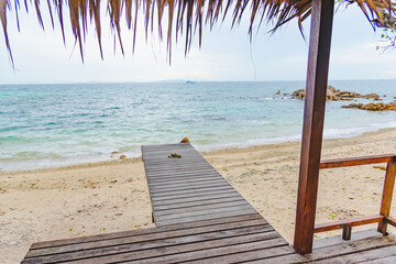 Nature in twilight period which including of sunrise over the sea and the nice beach. Summer beach with blue water and purple sky at the sunset.