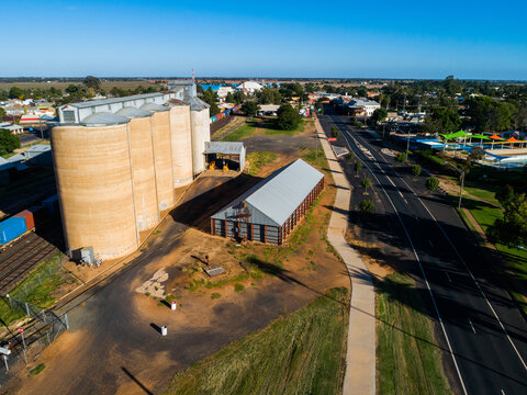 Aussie country town scene in Narromine of grain silos beside railway and freight train
