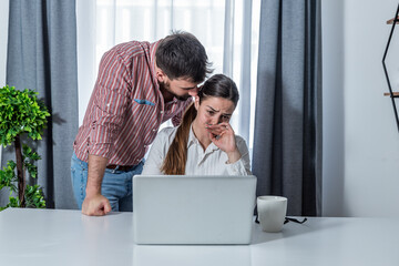 Male boss making woman worker stressed in the company office on her probation work period to see how she will handle with stress on her job  - obrazy, fototapety, plakaty