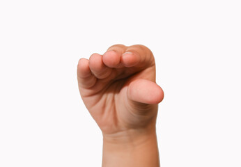 Children hand showing finger pinching gesture, isolated, close-up