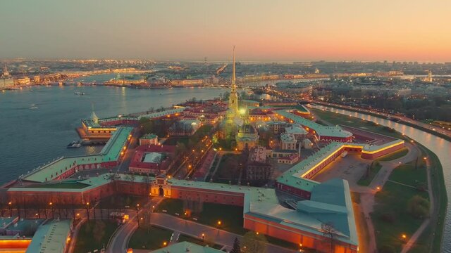 The flight around the Peter and Paul cathedral and fortress at evening, the sights of St. Petersburg, the Neva river, the Winter Palace, Rostral columns, bridges, St. Isaac cathedral, the Admiralty