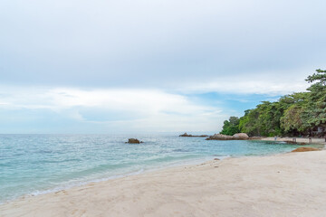 Nature in twilight period which including of sunrise over the sea and the nice beach. Summer beach with blue water and purple sky at the sunset.	
