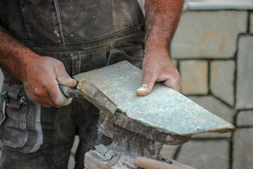 bricklayer
at work with stone