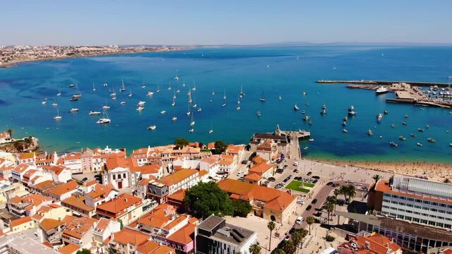 Ocean view in Cascais, Portugal. Many sailboats in one place, a view from a height. European houses with red tiles from a height.