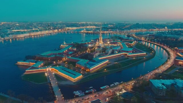 Drone flies off the Peter and Paul cathedral and fortress at evening, the sights of St. Petersburg, the Neva river, the Winter Palace, Rostral columns, bridges, St. Isaac cathedral, the Admiralty