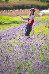 fashionable portrait of a young beautiful girl in a field, in flowers