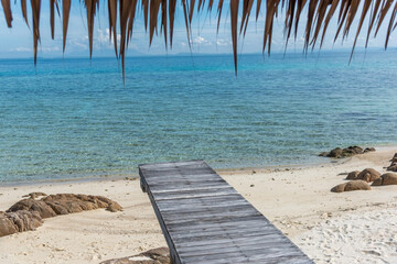 Nature in twilight period which including of sunrise over the sea and the nice beach. Summer beach with blue water and purple sky at the sunset.	
