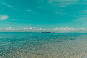 Nature in twilight period which including of sunrise over the sea and the nice beach. Summer beach with blue water and purple sky at the sunset.	
