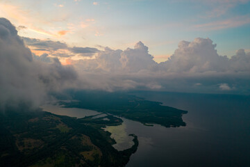 Aerial view of rain clouds over the valley and the Kiev Sea at sunset
