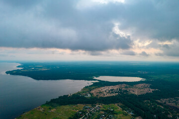 Fototapeta na wymiar Aerial view of rain clouds over the valley and the Kiev Sea at sunset