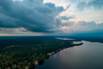 Aerial view of rain clouds over the valley and the Kiev Sea at sunset