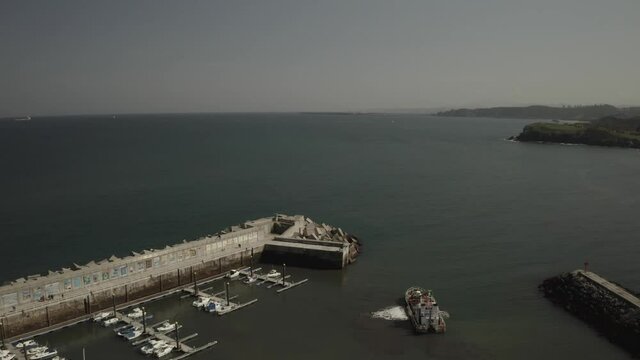 Aerial video view of the port, the lighthouse and the town of Candás, Asturias. Spain.