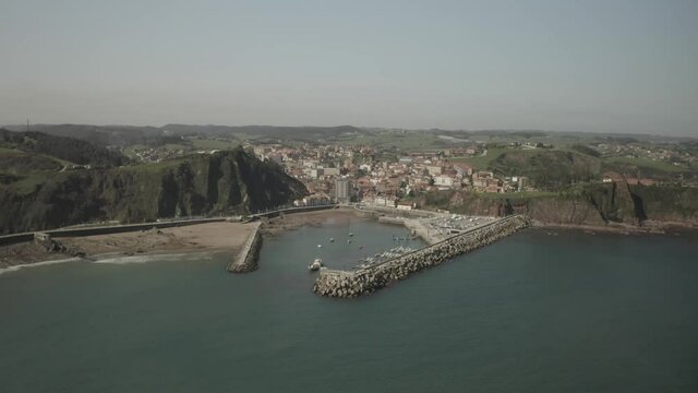 Aerial video view of the port, the lighthouse and the town of Cand&aacute;s, Asturias. Spain.
