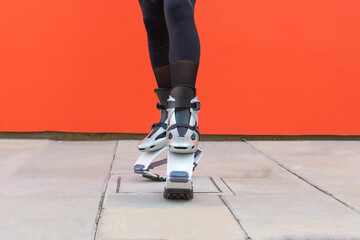 closeup of a woman's legs wearing kangoo jumps boots during physical training