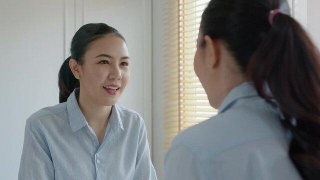 Young adult female asia people self love cheer up pep talk before job interview deep breathe inhale standing look in front of mirror smile at home in mental health care or work career stress relief.