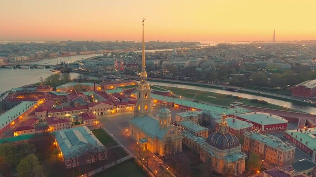 The flight around the Peter and Paul cathedral and fortress at evening, the sights of St. Petersburg, the Neva river, the Winter Palace, Rostral columns, bridges, St. Isaac cathedral, the Admiralty