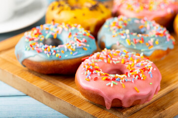 Delicious assorted colorful donuts on the table.